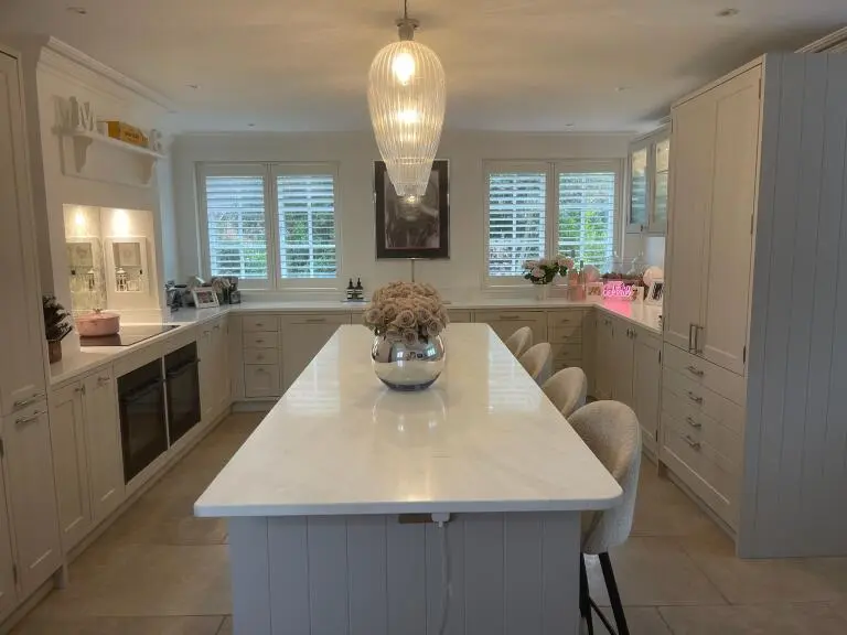 White shutters across kitchen windows